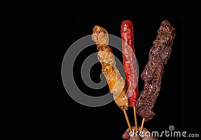 Assorted skewers on black background Stock Photo