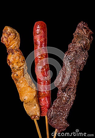 Assorted skewers on black background Stock Photo