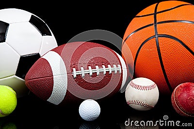 Assorted sports balls on a black background Stock Photo