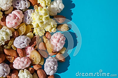 Assorted of sugared dried fruits, nuts and dragees in sugar, on blue background with copyspace Stock Photo
