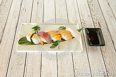 Assorted sushi mix tray with salmon nigiri, uramaki california roll, tuna and avocado maki, nori seaweed, Stock Photo