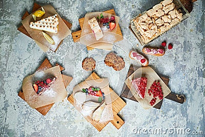 Assorted sweet desserts. Top view. Gray textured background. Beautiful serving dishes. Dessert. Food chain Stock Photo