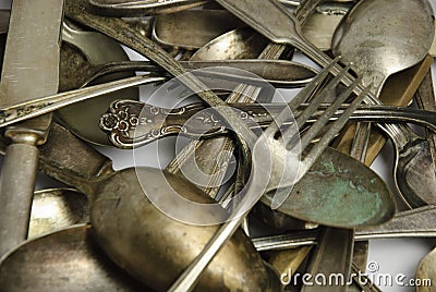 Assorted tarnished antique flatware on White Stock Photo