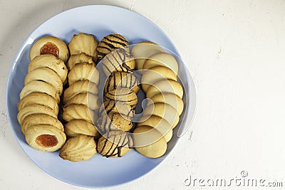 Assorted tea pastes on a blue plate from above Stock Photo