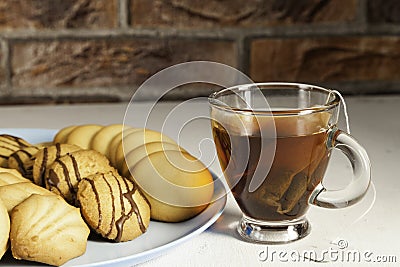 Assorted tea pastes on a blue plate and tea cup Stock Photo