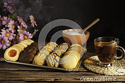 Assorted tea pastes, tea cup and sugar bowl Stock Photo