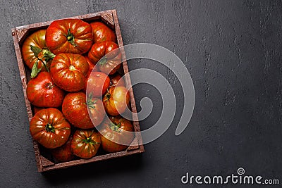 Assorted tomatoes in rustic crate Stock Photo