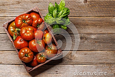 Assorted tomatoes in rustic crate Stock Photo