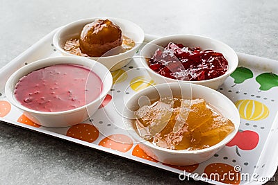 Assorted Variety of Jams and Marmalades; Rose, Red Pepper, Mandarin and Citron Peel in Small Bowl. Stock Photo