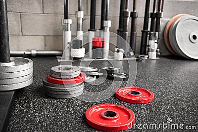 Assorted weights scattered on the floor of a gym Stock Photo