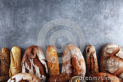 Assortment of baked bread and bread rolls on stone table background Stock Photo