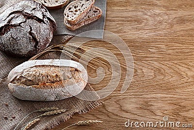 Assortment of baked bread on wooden background Stock Photo