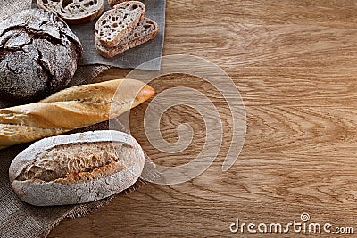 Assortment of baked bread on wooden background Stock Photo