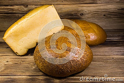 Assortment of baked bread on wooden table Stock Photo