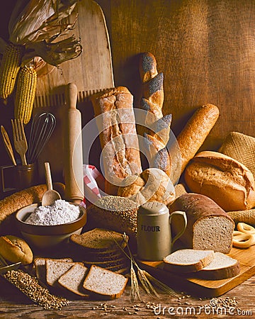 Assortment of baked breads on wooden table. Stock Photo