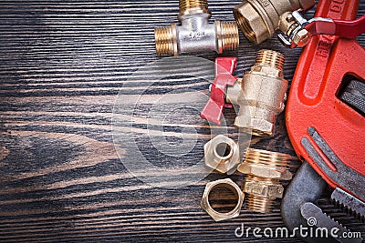 Assortment of brass plumbing equipment on wooden board copy spac Stock Photo