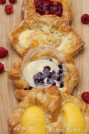Assortment of cheese danishes puff pastry with blackberries, vanilla custard, cherry jam and fresh raspberries Stock Photo