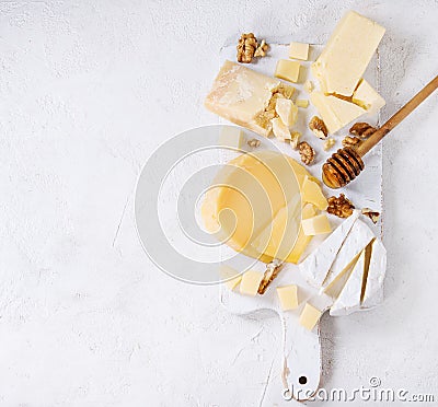 Assortment of cheese on wooden board Stock Photo