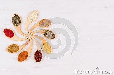 Assortment colorful powdered spices in bamboo spoons as decorative flower. Stock Photo