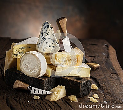 Assortment of different cheese types on wooden background. Cheese background Stock Photo