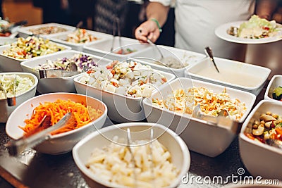 Assortment of fresh dishes displayed in hotel buffet. Variety of food in canteen ready for dinner Stock Photo