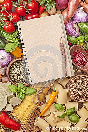 Assortment of fresh vegetables and blank recipe book Stock Photo