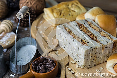 Assortment freshly baked bread rolls lightly dusted with flour on a wooden table Stock Photo