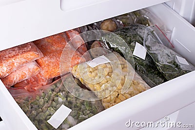 Assortment of frozenVegetables in home fridge. Frozen food in the refrigerator. Stock Photo