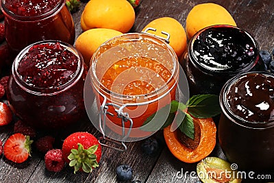 Assortment of jams, seasonal berries, apricot, mint and fruits. Stock Photo