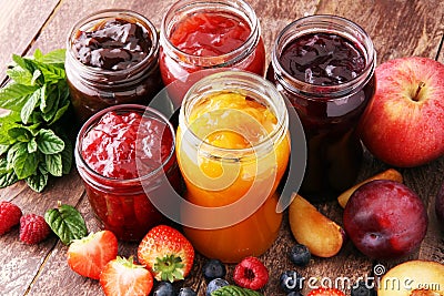 Assortment of jams, seasonal berries, plums, mint and fruits. Stock Photo