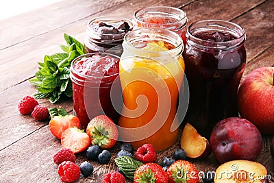 Assortment of jams, seasonal berries, plums, mint and fruits. Stock Photo