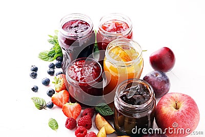 Assortment of jams, seasonal berries, plums, mint and fruits Stock Photo