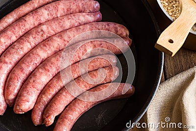 Assortment of raw uncooked sausages traditional Spanish type in iron cast pan, kitchenware Stock Photo