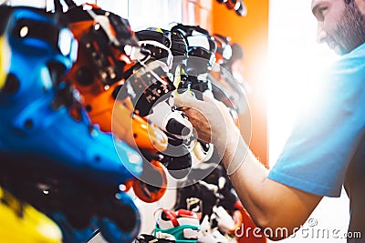 Assortment roller skates isolated in store shop, person choosing and buy color roller-skates on backgraund sun flare, healthy and Stock Photo