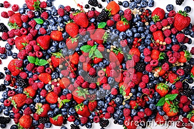 Assortment of strawberry, blueberry, currant, mint leaves. Summer berries background with copy space for your text. Top Stock Photo