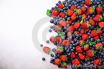 Assortment of strawberry, blueberry, currant, mint leaves. Summer berries background with copy space for your text. Top Stock Photo