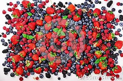 Assortment of strawberry, blueberry, currant, mint leaves. Summer berries background with copy space for your text. Top Stock Photo