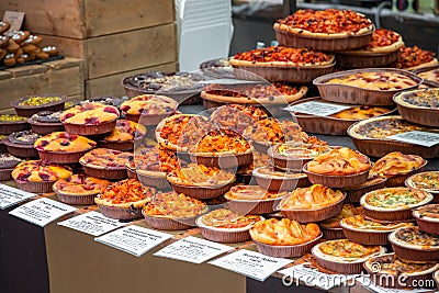 Assortment of tarts and quiches on display at Broadway Market in Hackney, East London Editorial Stock Photo