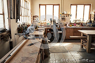 Assortment of tools on workbenches in a woodworking shop Stock Photo