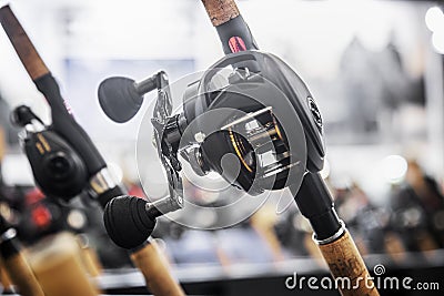 an assortment of trolling fishing reels on the counter of a fishing store Stock Photo