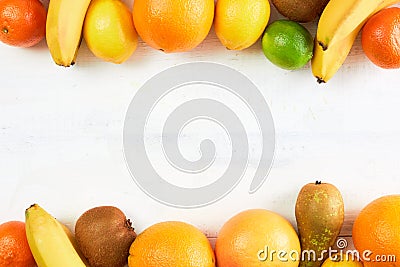 Assortment of tropical fruits orange, tangerine, banana, grapefruit, lemon, lime, kiwi on white background. Copy space. Stock Photo