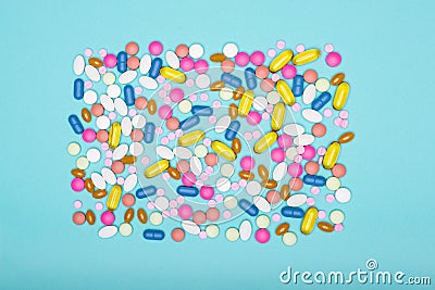 Assortment of various colourful pills on pastel coloured background. Medication and prescription pills flat lay. Stock Photo