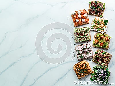 Assortment vegan sandwiches on white marble Stock Photo