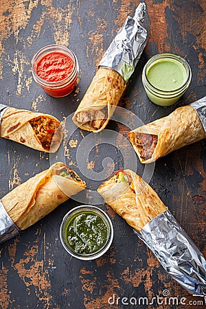 Assortment of wraps Reshmi Tikka, chicken tikka, bhuna, Aloo Corn or potato Corn paratha roll kathi shawarma with dipping sauce Stock Photo