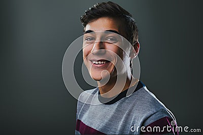 Assured, stylish youth laughs with relaxed ease Stock Photo
