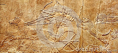 Assyrian wall relief of lion hunt, king Ashurbanipal with warriors on carving from Middle East and Mesopotamia Stock Photo