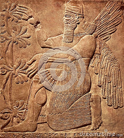 Assyrian wall relief of a winged genius Stock Photo