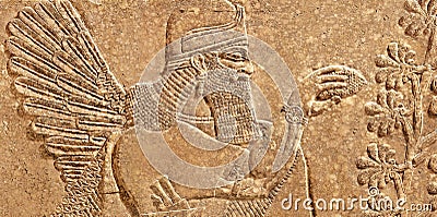 Assyrian wall relief of winged genius Stock Photo