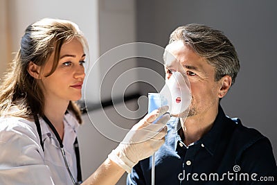 Asthma COPD Breath Nebulizer And Mask Given By Doctor Stock Photo