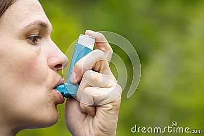 Asthma patient inhaling medication Stock Photo